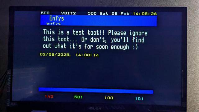 A photo of a TV displaying a teletext page of a toot, it says "Enfys, enfys, This is a test toot!! Please ignore this toot... Or don't, you'll find out what it's for soon enough :) 02/08/2025, 14:08:14
