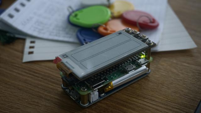 It's an electronics sandwich! A battery board is the lowest part. On top of that there is a Pi Zero 2 W mounted. It connects via pogo-pins. On top of that is an E-Ink screen HAT. All that is mounted together with standoffs.