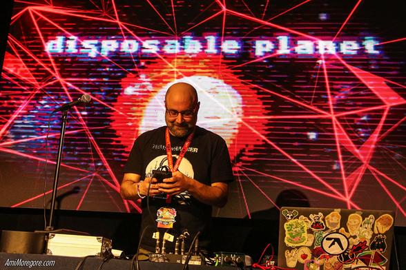Disposable Planet playing on stage with a m8 tracker in his hands