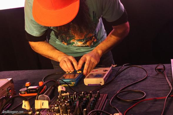 Close up of Defense Mechanism playing two gameboys