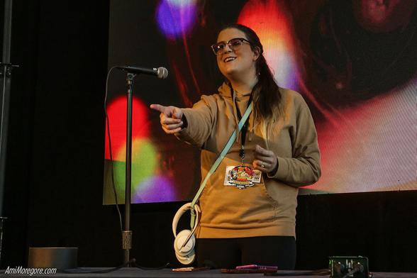 Sybil Grace performs while pointing to the audience
