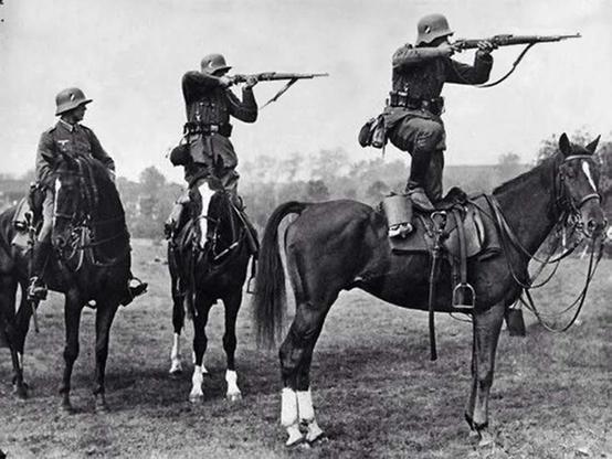 German cavalry aim rifles from horseback