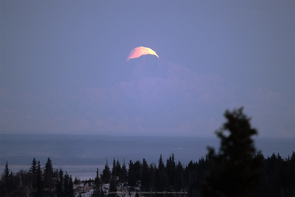 The setting moon right behind the summit of Denali on the horizon