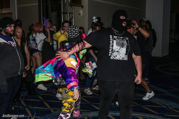Sage Hardware performs while the crowd moshes around him