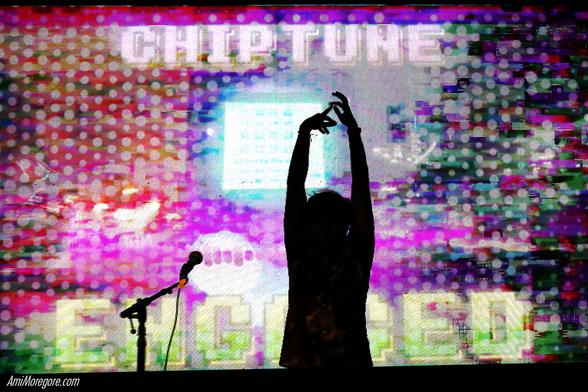 A silhouetted artist raising hands while visual in the background states "Chiptune Engaged" in caps