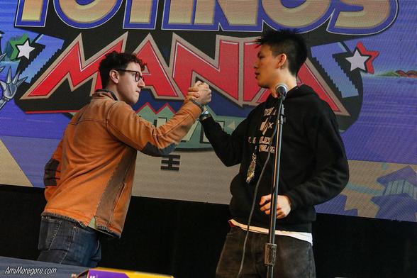NewGuy and RH Man  clasp grips on stage intensely