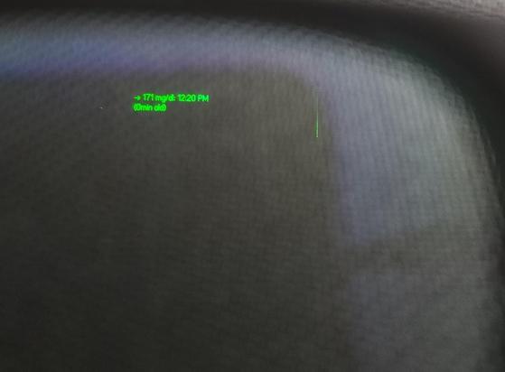 A through the lens photo of a text based glucose notification on the G1 glasses using the Reläa app.

It shows a symbol of if the glucose is trending up down, or neutral, the current glucose value in mgdl or mmol, the time of the reading, and how long ago that reading was.