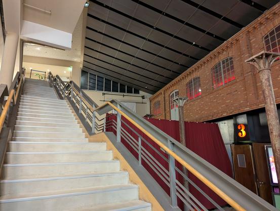 Inside the cinema building you see many red brick walls, remains from the old buildings that were here before and have been incorporated into the modern re-purposed structure.