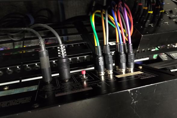 Back view of Yamaha MT44D cassette multitrack recorder. Footswitch cable, remote control cable, latching switch, 4 inputs and 4 outputs with color coded cables