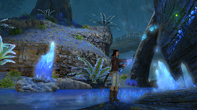 My Final Fantasy 14 main Miqo'te fishing at the base of a tree that has pale blue crystals at its base in a lake in the middle of a turquoise, green and blue-tinged forest.