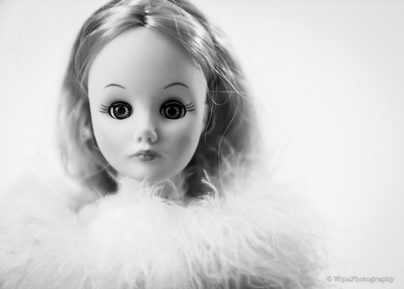 Image of a doll with fuzzy scarf