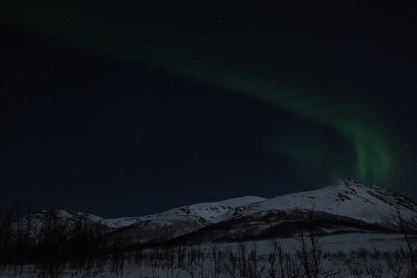 Green Aurora in Norway. Mountains in the foreground/bottom 3rd of the image.