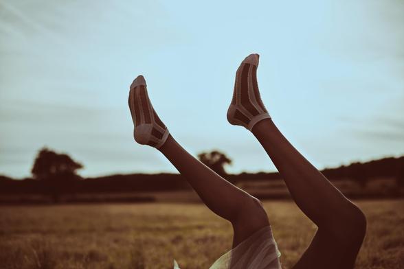 Editorial photograph of feet on an open field