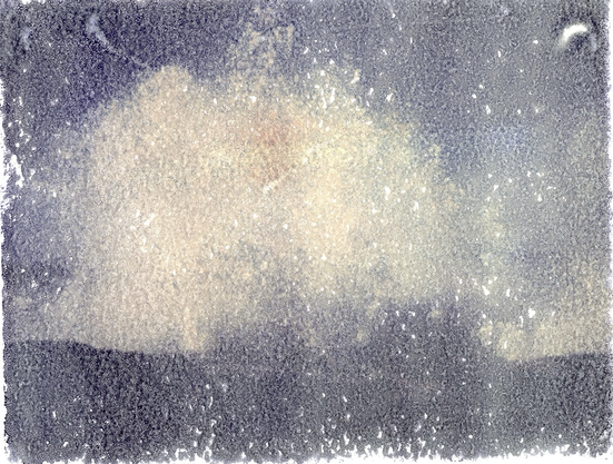 A polaroid transfer onto Arches platine paper. A picture of a wave crashing into rocks.