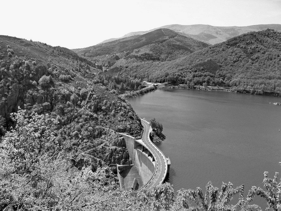 Road over a dam at Lac de Villefort (monochrome).