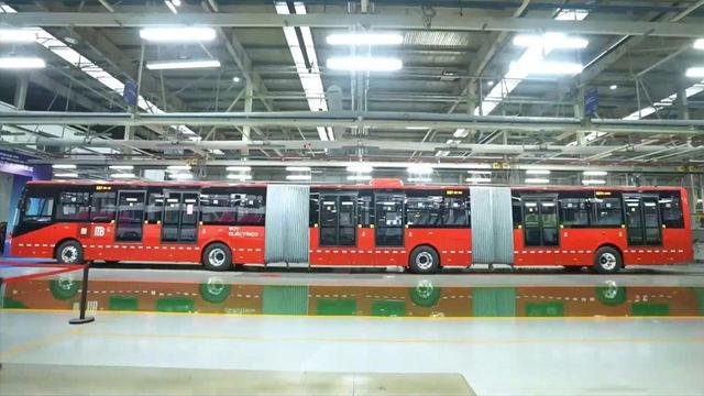 A large, red 26-meter Yutong electric bus