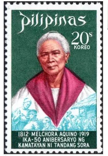 A postage stamp from the Philippines commemorating Melchora Aquino. The stamp features her portrait, with her wearing traditional clothing and a red scarf. The background is green with white text above reading "Pilipinas" and "20s KOREO." Below her image, there is text that includes her birth and death years (1812-1919) and celebrates the 50th anniversary of her death, stating "IKA-50 ANIBERSARYO NG KAMATAYAN NI TANDANG SORA."