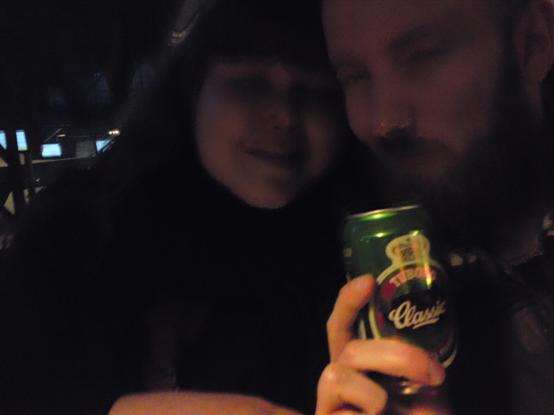 Kasper og Andrea på en mørk bogeda med en øl i hånden