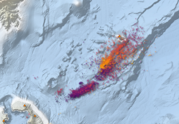Map showing many dark purple earthquakes to the southeast of Kolumbo volcano, and then extending northeast towards Anydros Island, along an existing fault line, the Anydros Fault.
