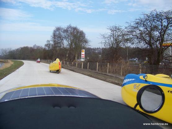 Velomobiles going along the new cyclepath. It's about 5 m wide, very smooth and really quite excellent. This is what we want ! At this point we pass another petrol station and again we don't buy any (I've not personally bought any type of fuel for a car since 2018).