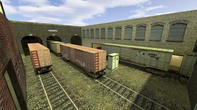 As in picture three, Trainyward B can be seen from diagonally above. Only from the other side, so you can see the three sidings that have a roof. You can now also see the second entrance on the right, which is behind the two white wagons in gate 4. This leads to Trainyard A and the Alleyway. And you can now also see the electrical box completely. This is on the map de_train in the game Counter-Strike 1.6.