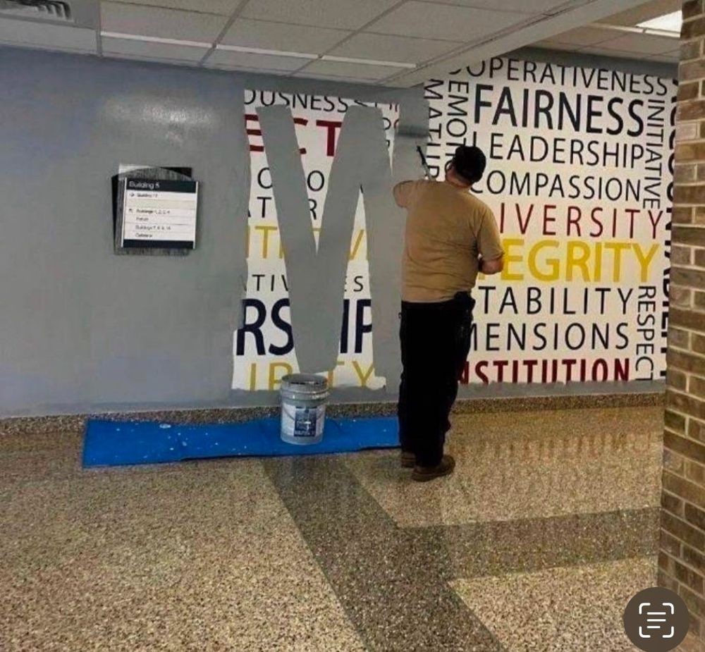 Wall covered with virtuous words in the FBI building being painted over, because one of them is "diversity"