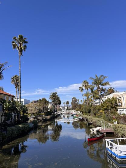 Looking down a canal in Venice California at one of the many picturesque white bridges.