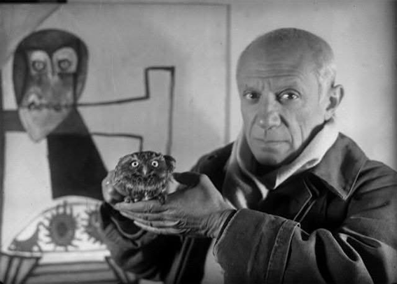 B/W photo by Michel Sima, 1946: Picasso holding his pet owl Ubu in front of a painting featuring his little friend (Owl on a Chair and Sea Urchins, 1946) - closer shot