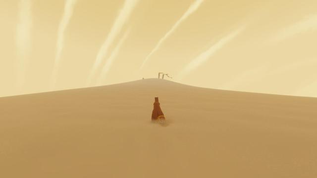 The opening scene of the game Journey; my traveler walks alone in the sands toward a distant structure