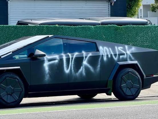 A Tesla "cybertruck" improved with text reading "Fuck Musk."