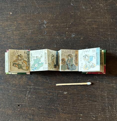 Inside pages of the miniature book featuring Ukiyo-e illustrations of women in Edo-era.
