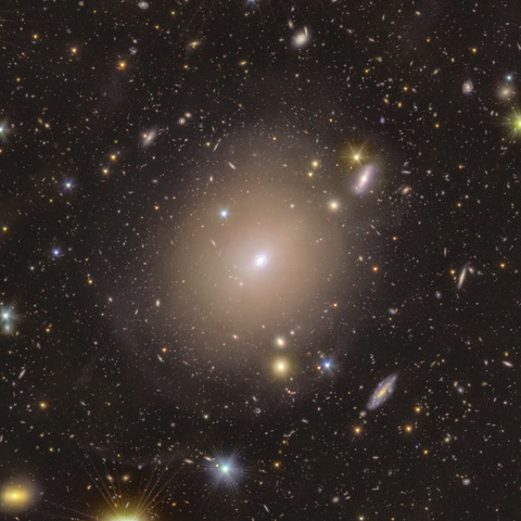 Full view of NGC 6505 and its environment of foreground stars and distant galaxies in the background. The Einstein Ring is visible in the very center only if you zoom in.