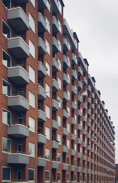 Apartments complex that looks identical i many rows and columns. Typical Danish red brick apartment with small and identical balcony’s. 1940s architecture.
