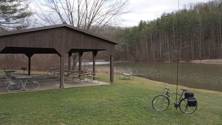 Image shows WD8RIF's antenna mast strapped to his bicycle at an Ohio State Park.