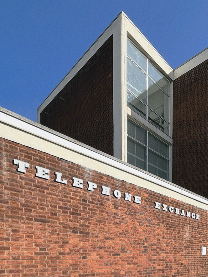 A colour photograph of the brick and glass facade of the telephone exchange at Hornchurch