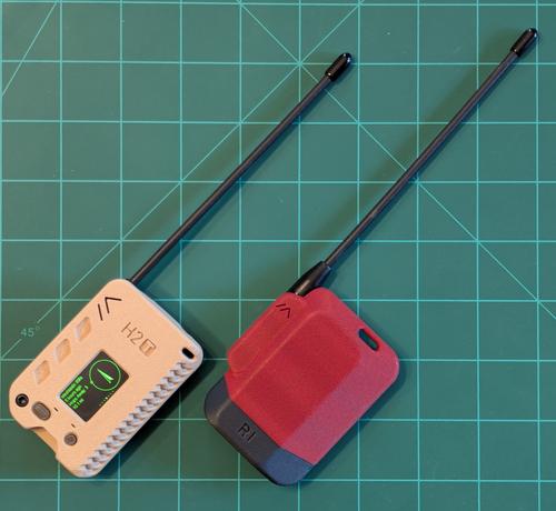 Two meshtastic devices. The h2t is on the left. It's a beige box with a screen. The GPS is pointing to the direction of the node it is picking up. 

On the right, is the R1. Essentially the same thing as the h2t but it has no screen or GPS and is in a red case.