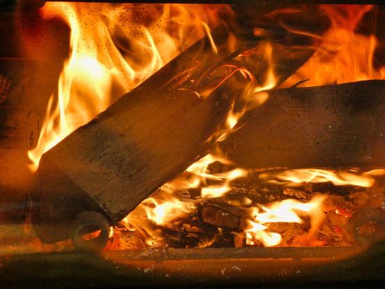 Logs burning in a fireplace.