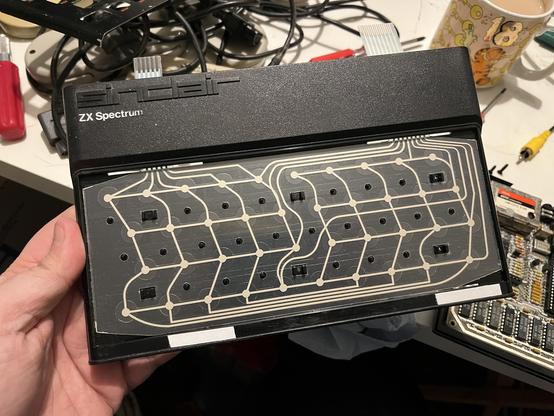 A Sinclair Spectrum with the keyboard removed and a bare membrane showing
