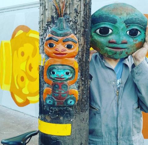 A pole mounted honey bear sculpture in the Mission District of San Francisco with self portrait.