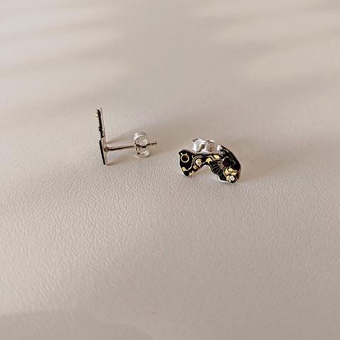 a pair of small stud earrings with an old tiny PCB with black and copper colors