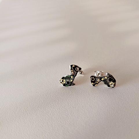 a pair of small stud earrings with an old tiny PCB with black and copper colors