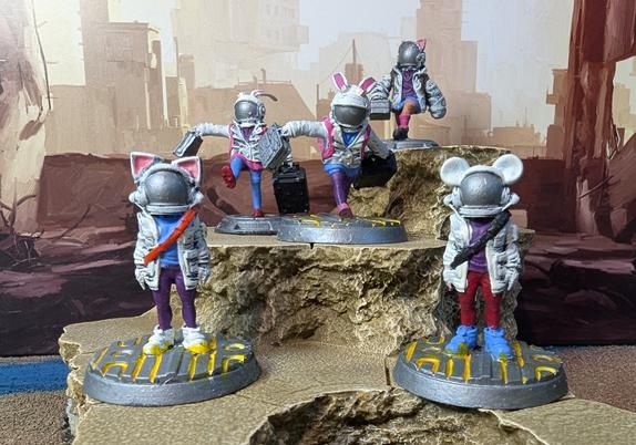 Miniature figures of the young delivery staff from a Metro Otherscape ttrpg game. The young staff wear space helmets with animal ears on them.