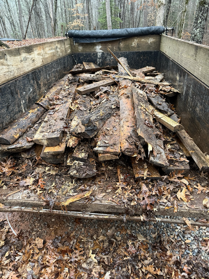 A pile of milled log castoffs in a dump trailer