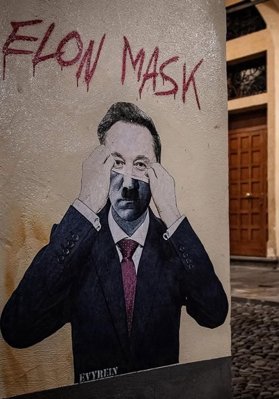 (Painting by Banksy of Musk pulling up his mask to reveal Hitler underneath)  ELON MASK