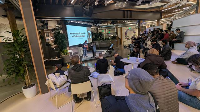 A photo from the back of GitHub HQ quad. Ths presenter is Sam Poder (Hack Club) How we built a bank w/ Ruby on Rails