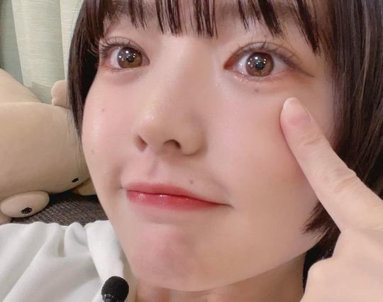 Fuuka smiling touching her cheek.