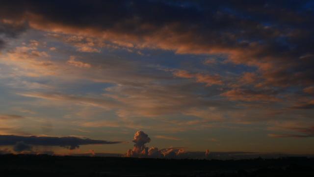 A wide horizon with majestic cloudscape, pink tinged clouds during the sunrise, Malta, Mediterranean.