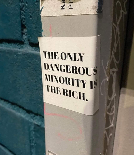 Bild eines Pfostens auf welchen ein weißer Sticker auf welchem in schwarz „the only dangerous minority is the Rich“ steht 

Source: https://streetartutopia.com/2025/02/10/street-protest/