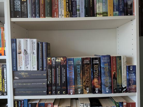 A picture of a shelf full of books by Brandon Sanderson