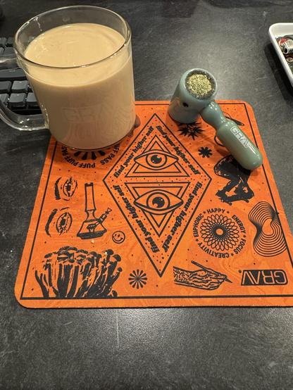 Cup of coffee in a grav boro cup on a orange grav drop mat with a grav hand hammer bowl